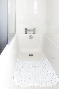 a white bath tub with a silver faucet at Fair Haven - Off Street Parking and Garden in Shrewsbury