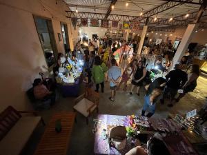 a crowd of people standing in a room at Rincon Dorms in Rincon