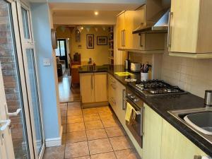 a kitchen with a sink and a stove top oven at Beautiful home perfect for families&professionals in Nantwich