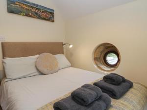 a bedroom with a bed with towels on it at Foulsyke Farm Cottage in Saltburn-by-the-Sea