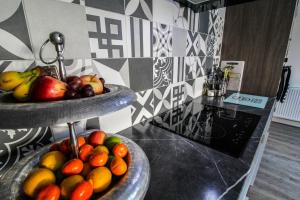 two bowls of fruit on a counter in a kitchen at Sandy feet retreat in Exmouth