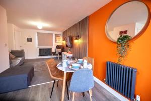 a living room with a table and chairs and a living room at Willoughby House Beeston Nottingham in Nottingham