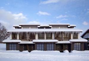 a building covered in snow in the snow at Kasara Niseko Village Townhouse - Small Luxury Hotels of The World in Niseko