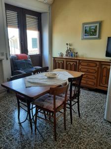 a living room with a table and chairs at Sweet Home in Oliena