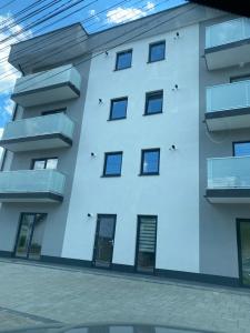 a white building with windows and balconies at Luxury king in Câmpulung Moldovenesc