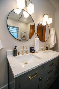 a bathroom with a sink and a mirror at Gulf Coast Craftsman - Cozy, Charming & Central! in Gulfport