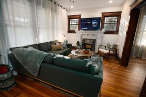 a living room with a couch and a fireplace at Gulf Coast Craftsman - Cozy, Charming & Central! in Gulfport