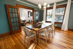 a dining room with a wooden table and chairs at Gulf Coast Craftsman - Cozy, Charming & Central! in Gulfport