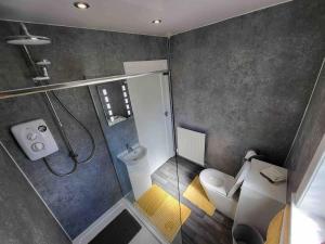 a small bathroom with a shower and a toilet at Beinn Brèagha in Fort William