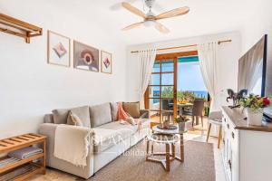 a living room with a couch and a table at Oceanfront Holiday with Stunning Views in San Miguel de Abona