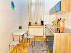 eine Küche mit einem Tisch und 2 Hockern in der Unterkunft Studio Apartment in attraktiver und zentraler Lage in Berlin
