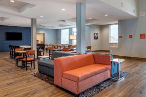 a waiting room with a couch and chairs and tables at Best Western Plus Desert View Inn & Suites in Cathedral City