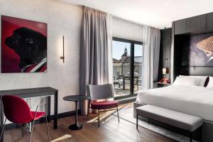 um quarto de hotel com uma cama e uma lareira em Radisson RED Madrid em Madri