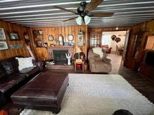 a living room with a couch and a ceiling fan at Quiet Farmhouse IN THE COUNTRY close to major theme parks in Ridge Manor