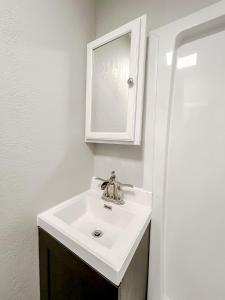a bathroom with a sink and a mirror at Sleepover Historic Downtown Springfield Apartments in Springfield
