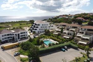 an aerial view of a resort with a pool at The beach House- 1Room Apartment at Blue Bay resort in Sint Michiel