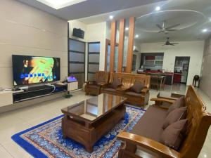 a living room with couches and a flat screen tv at 25PAX 5BR Villa Kids Swimming pool, KTV, BBQ near SPICE Arena Penang 9800 SQFT in Bayan Lepas