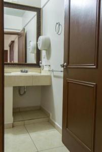 W łazience znajduje się umywalka i lustro. w obiekcie HOTEL DEL CENTRO w mieście Ciudad Obregón