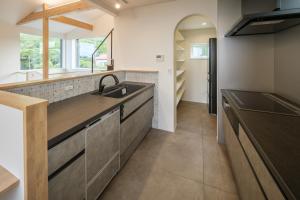 a kitchen with a sink and a counter at KeiU-Yakushima Luxury Guest House in Yakushima