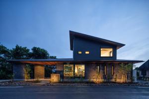 a contemporary house with a black roof at KeiU-Yakushima Luxury Guest House in Yakushima