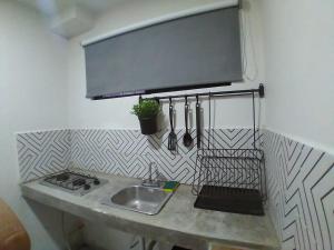a kitchen with a sink and a counter top at APARTAMENTOS AMBASSADOR in Tijuana