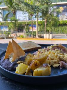 a blue plate with food on a table at Alma y Mar Apart Hotel 5th Av in Playa del Carmen