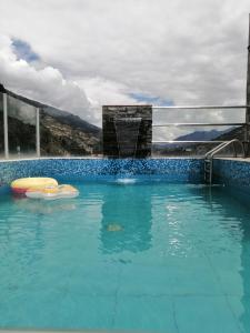 a large swimming pool with blue water at Los Ángeles Suite Hotel in Chavín de Huantar