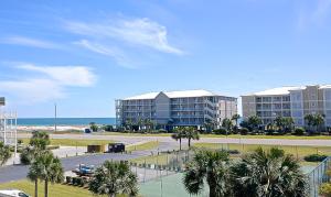 a view of a resort with palm trees and the ocean at Dolphin Harbor 3C in Orange Beach