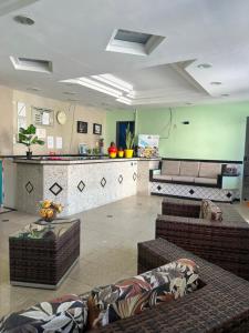 a lobby with couches and a bar in a building at Pousada Ferreira in Aracaju