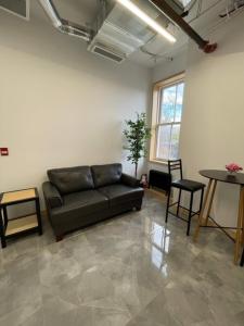 a living room with a couch and a table at Sandwich Boutique Hotel in Windsor