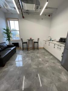 a kitchen and a living room with a couch and a table at Sandwich Boutique Hotel in Windsor +5 photos