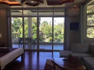 a living room with a couch and a table at Camiguin Lanzones Resort in Mambajao