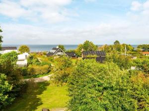 a view of a village with the ocean in the background at 10 person holiday home in Alling bro in Nørager
