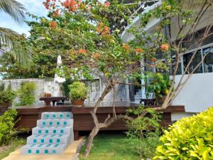 a garden with a tree and a blue bench at Yao Yai Beach Resort in Ko Yao Yai