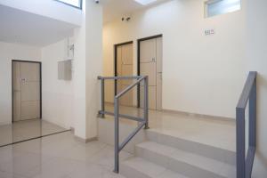 a hallway with stairs and lockers in a building at RedDoorz near Malioboro Mall 2 in Yogyakarta