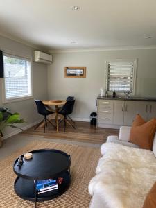 a living room with a couch and a table at Foehn Cottage in Twizel