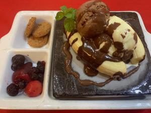 a plate of ice cream and fruit on a tray at Huon Gulf Hotel in Lae
