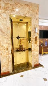 a lobby with a gold elevator in a room at Perles Villa - Venue Travel in Ha Long