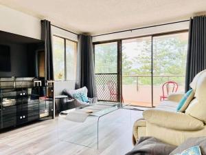 a living room with a glass table and a couch at Beachside spacious unit 9 in Tuncurry