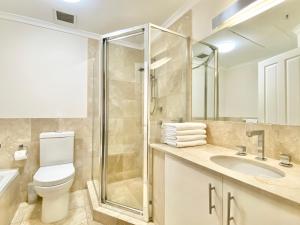 a bathroom with a toilet sink and a shower at Milson Serviced Apartments in Sydney