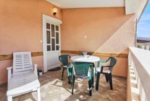 a patio with a table and chairs on a balcony at Apartments Jera- barbecue in Sevid