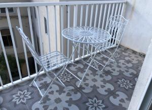 a table and two chairs sitting on a balcony at Lee House in Sliema