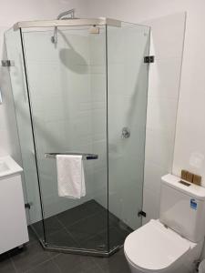 a shower stall in a bathroom with a toilet at H Boutique Hotel in Pokolbin