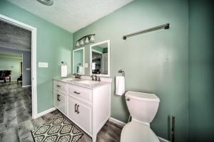 a bathroom with a white toilet and a sink at Spacious Geneva House Less Than 5 Mi to The Strip! in Geneva