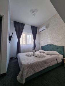 a bedroom with a bed and a window at Hotel AMA WORLD in Constanţa