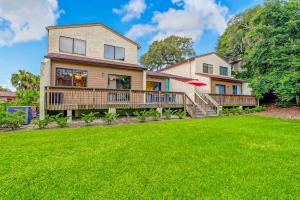 a house with a deck and a frisbee at Beachwalk Cozy Condo in Fernandina Beach