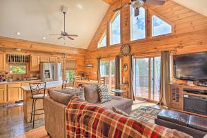 a living room with a couch and a tv at Grand Windham Retreat with Fire Pit and Game Room in Windham