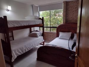 a room with two bunk beds and a window at El Refugio de la Estancia in Melgar