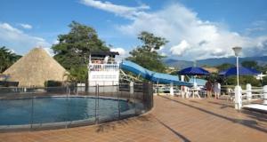 a resort with a slide and a swimming pool at El Refugio de la Estancia in Melgar