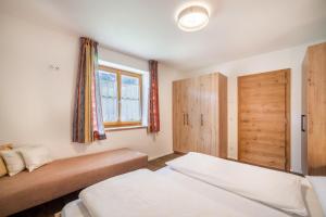 a bedroom with two beds and a window at Parigger Apt Lavendel in Racines